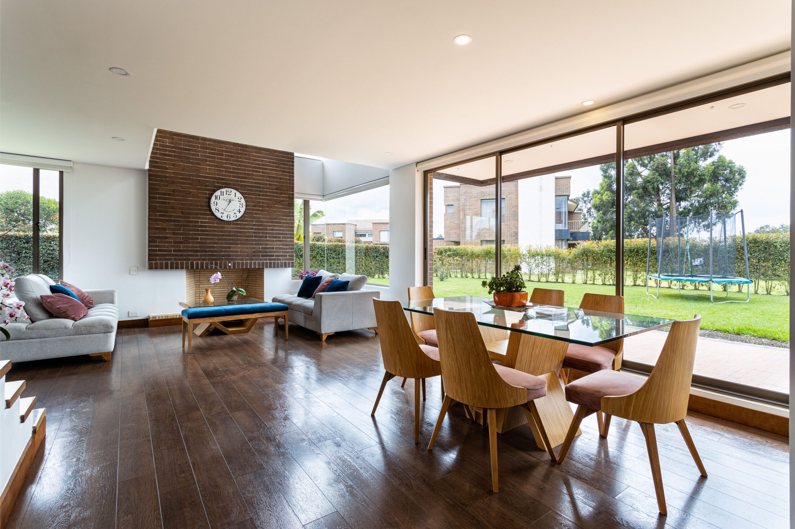Spacious living and dining area with glass windows and modern furnishings.